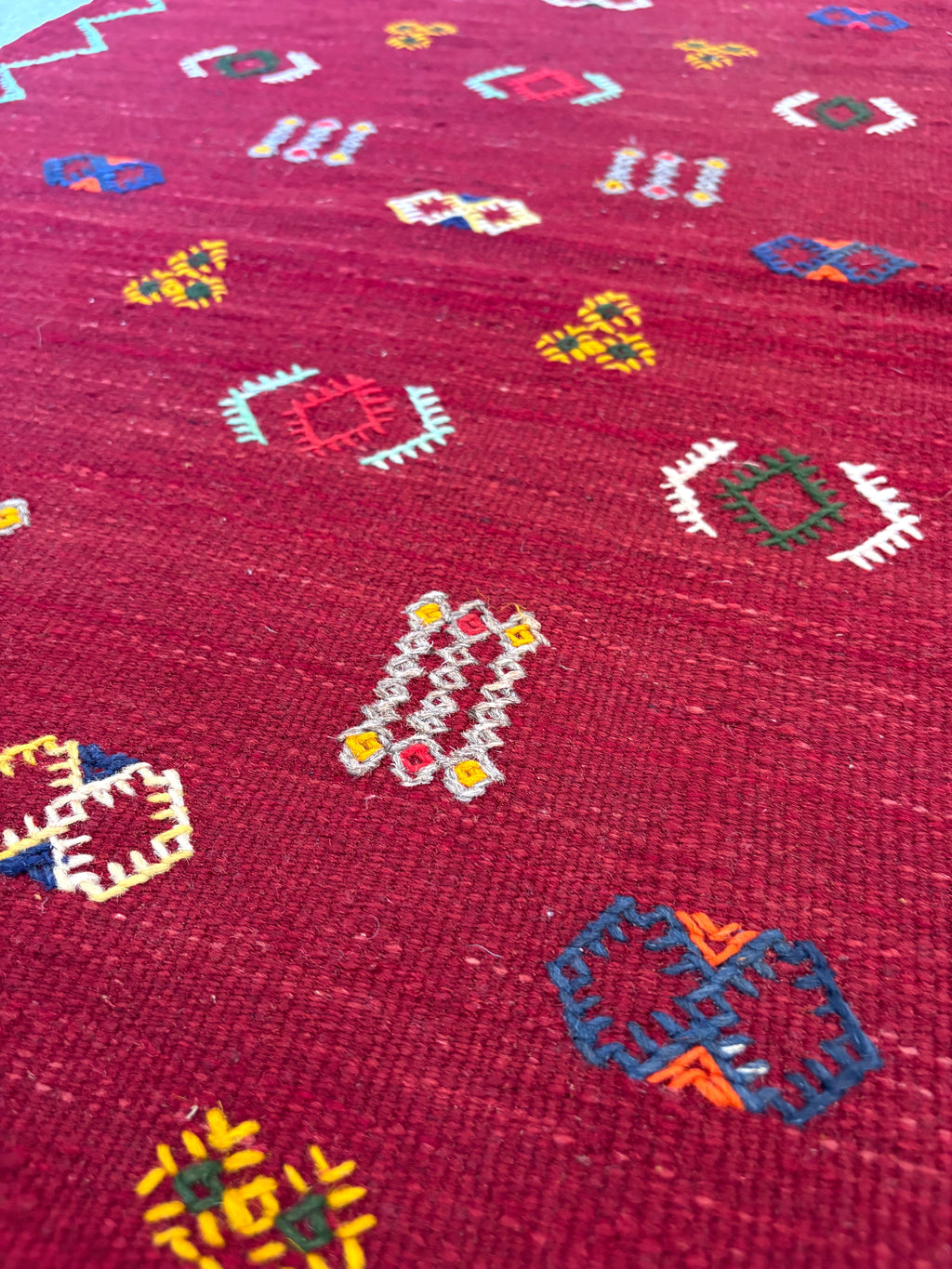Close-up of handwoven Amazigh motifs on a Moroccan small wool kilim rug