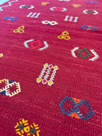 Close-up of handwoven Amazigh motifs on a Moroccan small wool kilim rug