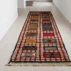 Full view of a handmade Moroccan runner rug with flatweave and knotted wool design