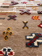 Close-up of handwoven Moroccan kilim rug showing intricate Amazigh symbols