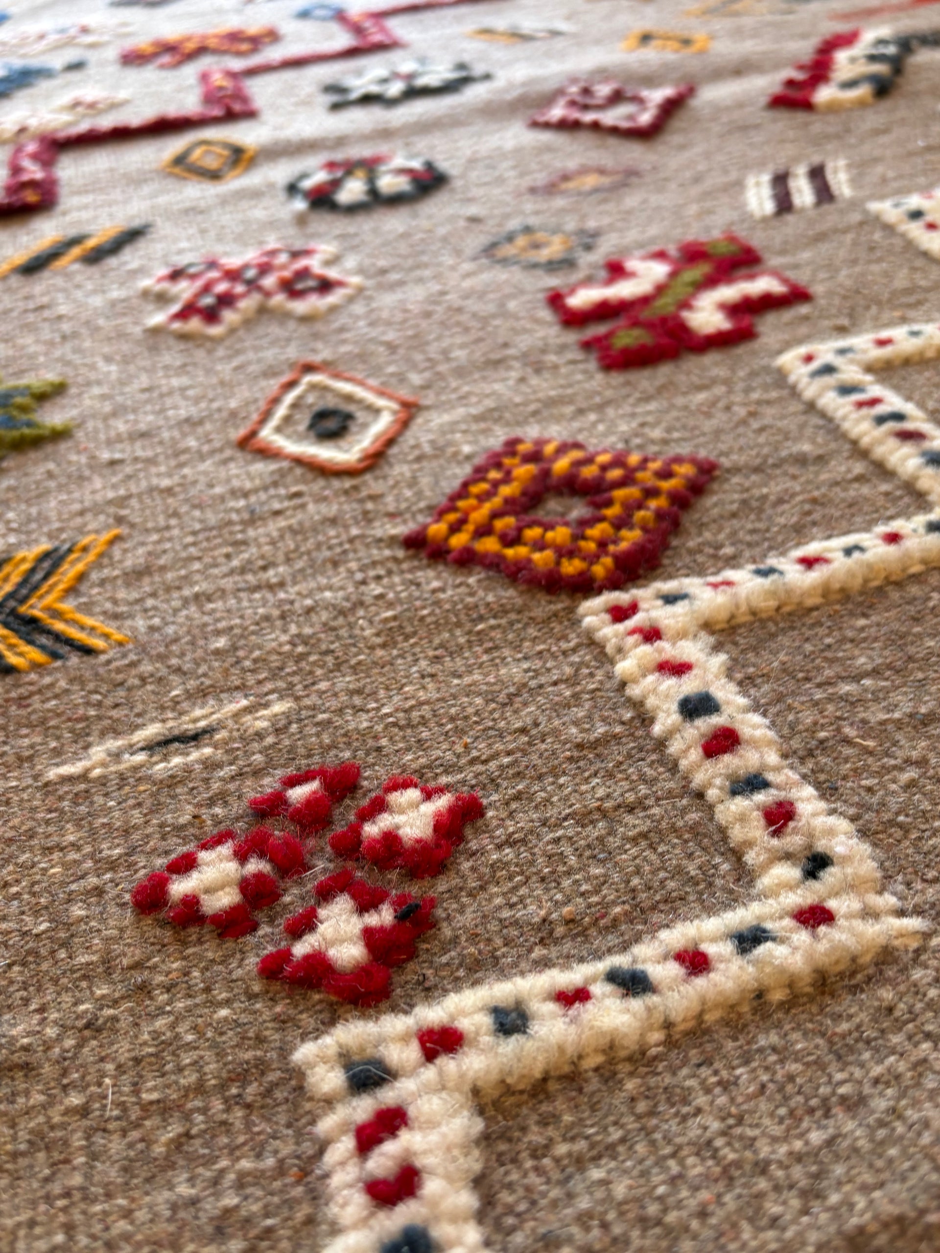 Traditional Amazigh symbols woven into a Moroccan Berber kilim rug