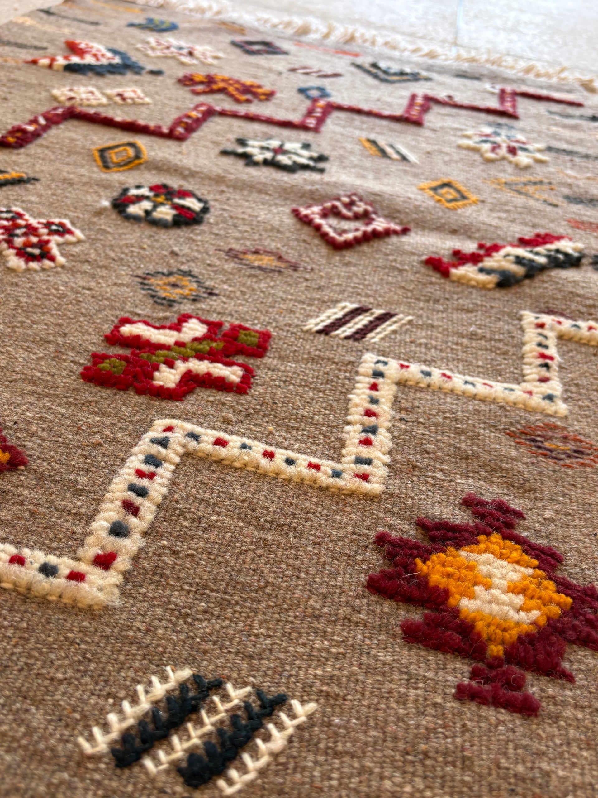Traditional Amazigh symbols woven into a Moroccan Berber kilim rug