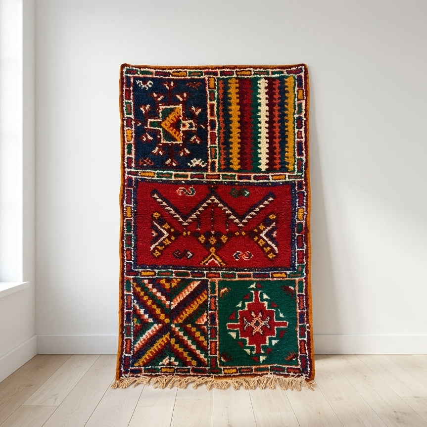 Hand-knotted Moroccan Berber patchwork rug in 100% Atlas Mountain wool featuring four Amazigh symbolic panels, 25 × 42 in (64 × 106 cm).