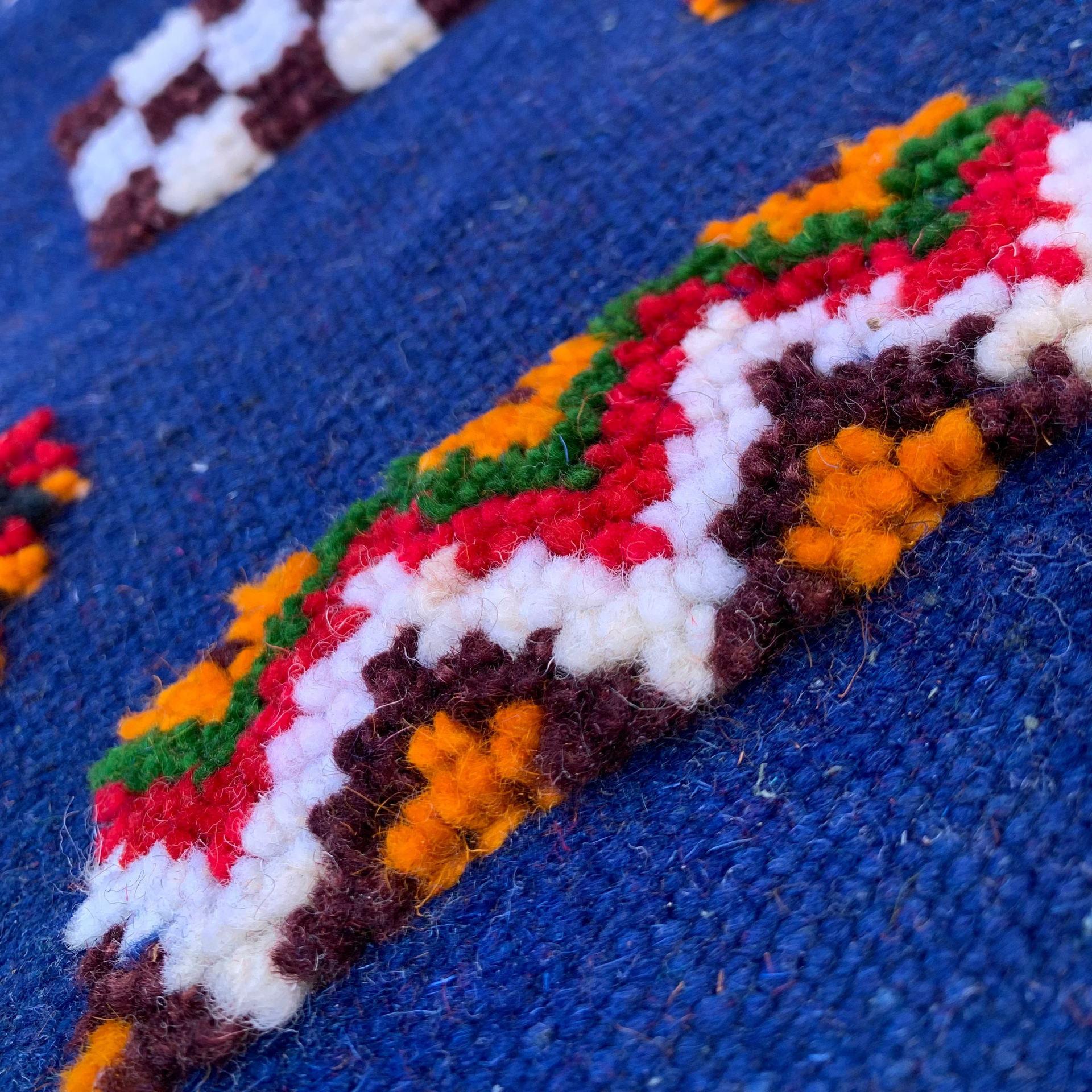 Close-up of a Moroccan rug – navy blue handwoven runner with symbols