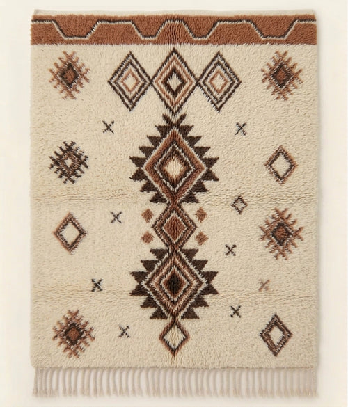 Atlas Line contemporary Beni Ouarain-inspired Moroccan rug design with an ivory base and brown geometric diamond motifs.