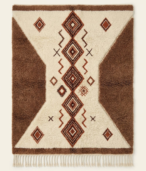 Atlas Passage Beni Ouarain custom Moroccan rug with cocoa geometric forms and protective diamond motifs on ivory wool