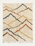Crossing Ridges Beni Ouarain custom Moroccan rug with indigo, terracotta, ochre and brown mountain-inspired lines on warm ivory wool