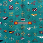 Close-up of Emerald Archive Taznakht rug showing raised hand-knotted motifs over a flatweave wool ground