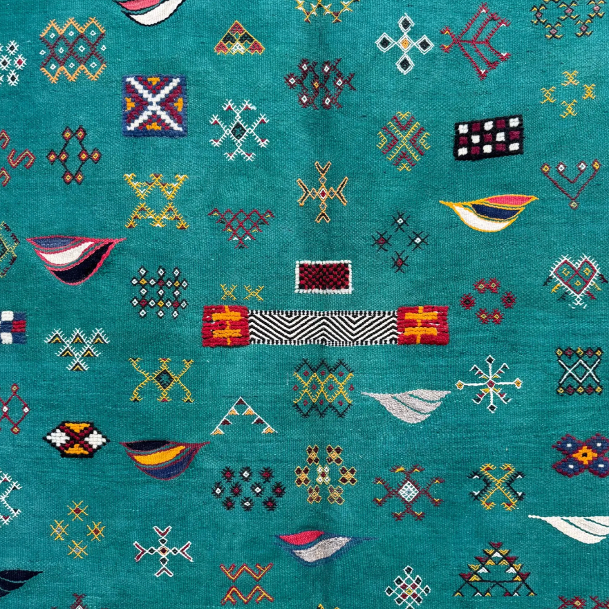Close-up of Emerald Archive Taznakht rug showing raised hand-knotted motifs over a flatweave wool ground