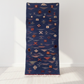 Navy blue rug with geometric pattern on a white floor and background