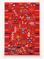 Scarlet Notes custom Taznakht rug with multicoloured hand-knotted motifs on a red flatweave wool ground