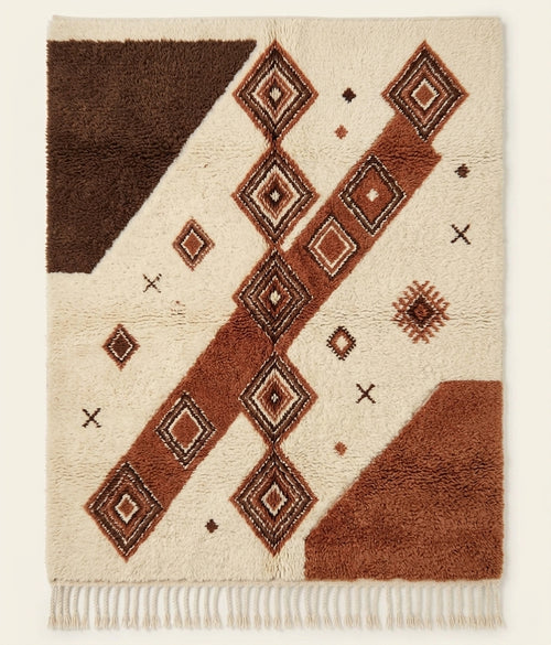 Terracotta Crossing contemporary Beni Ouarain-inspired Moroccan rug with an ivory base, terracotta diagonal forms and brown diamond motifs.